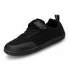 Zapato escolar barefoot negro para niño con puntera reforzada y suela flexible.